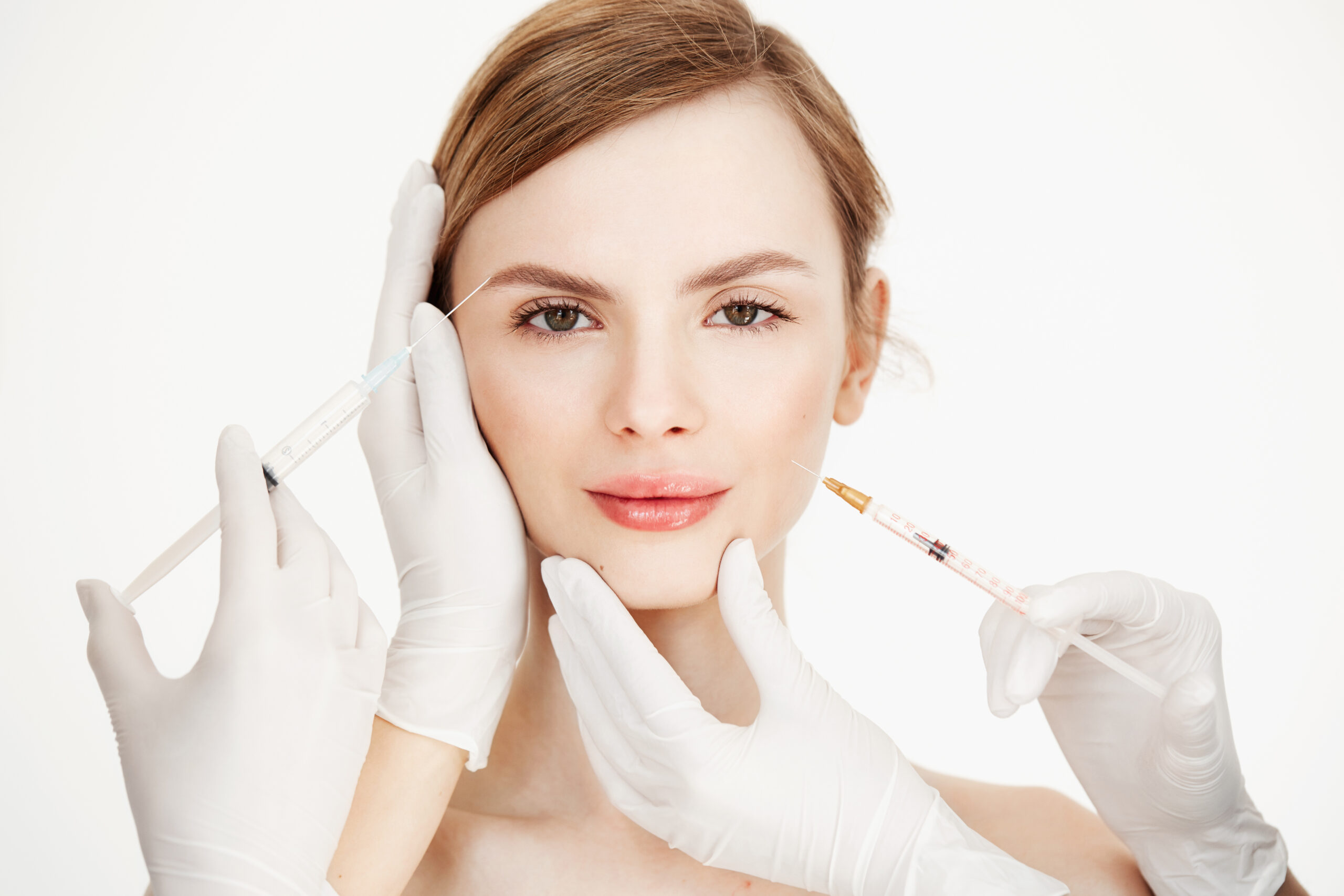 Cosmetologists hands making medical botox injections to beautiful blonde. Skin lifting. Facial treatment. Beauty and spa