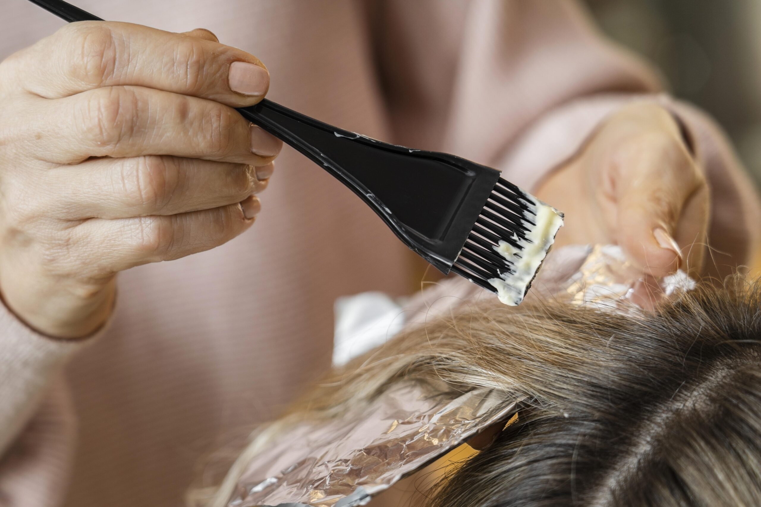 woman-getting-her-hair-dyed-home-by-beautician