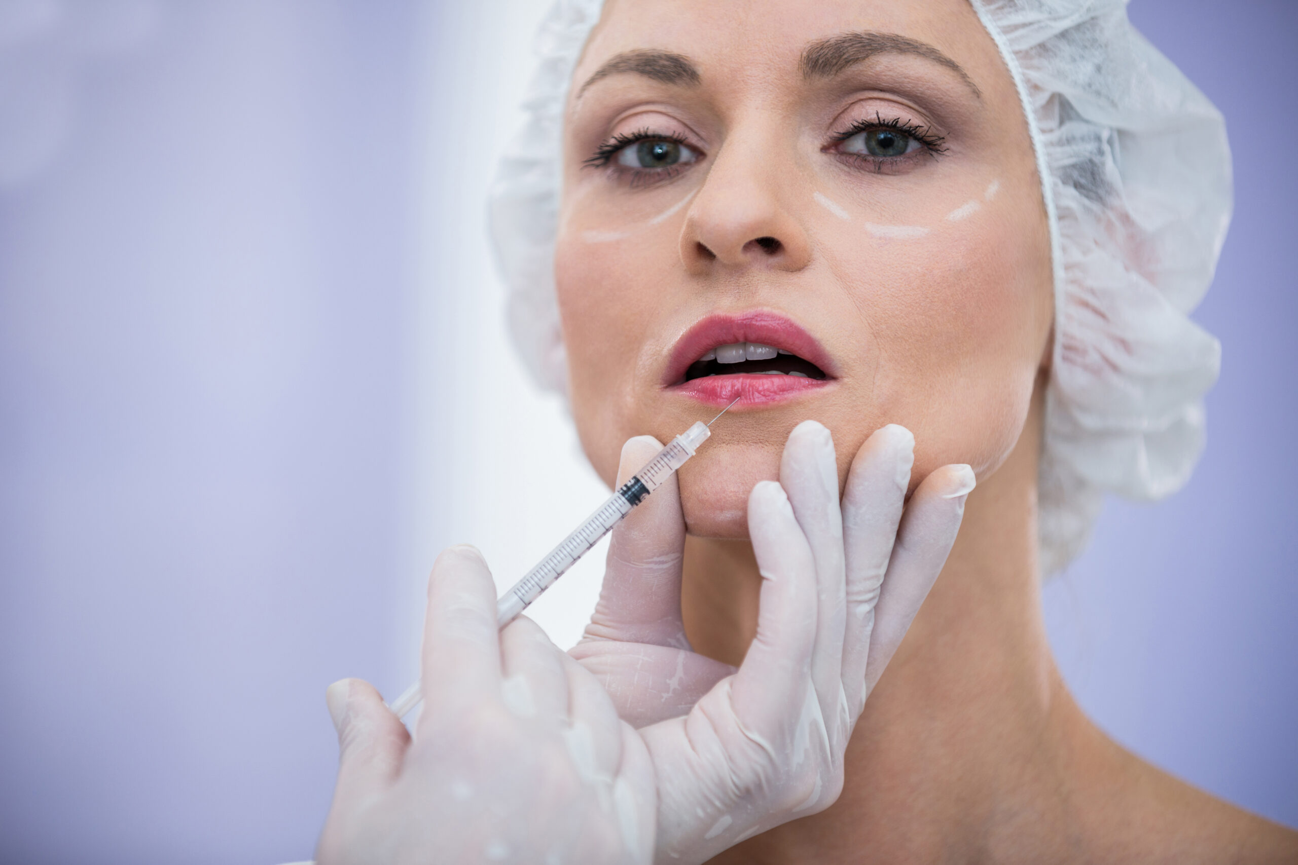Portrait of woman receiving botox injection at clinic